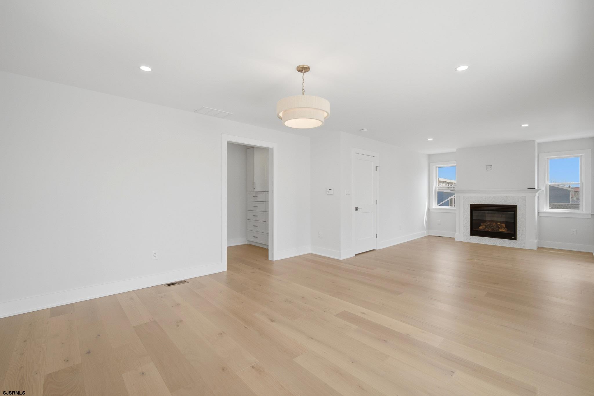 230 7th Street South Brigantine, NJ 08203 - Photo 26 of 87 a view of empty room with wooden floor and fireplace