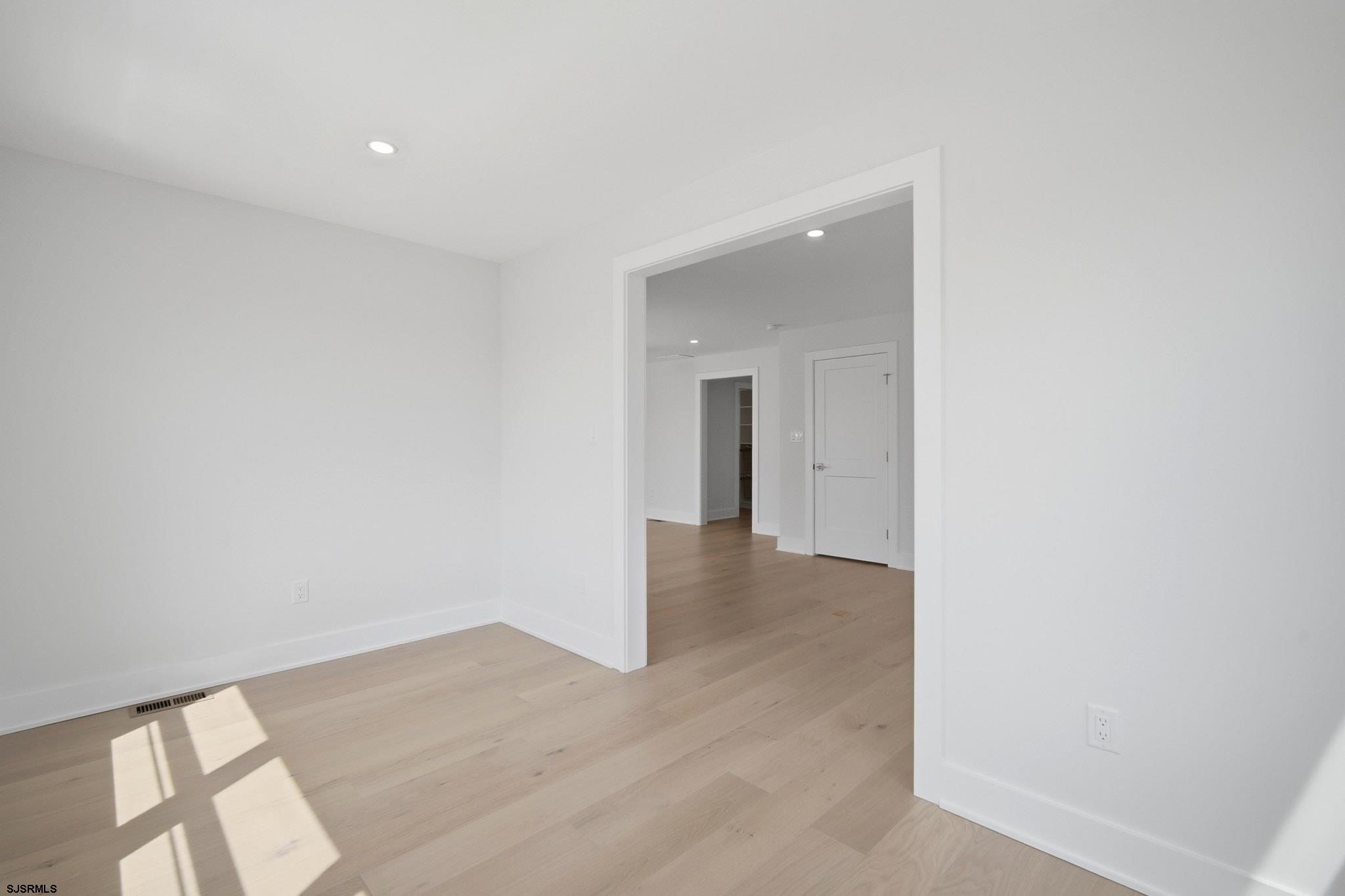 230 7th Street South Brigantine, NJ 08203 - Photo 30 of 87 a view of a hallway with wooden floor and a bathroom