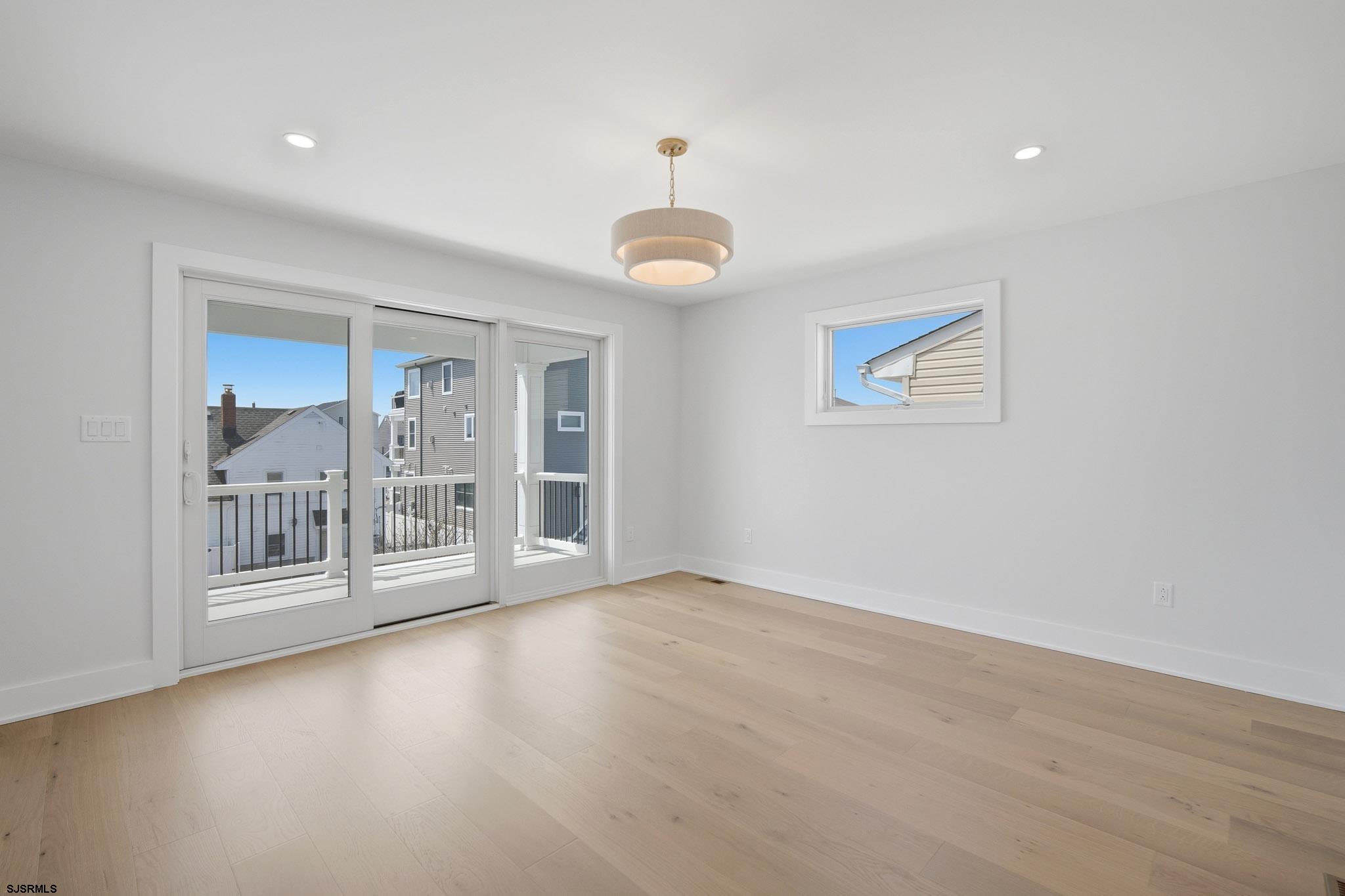 230 7th Street South Brigantine, NJ 08203 - Photo 32 of 87 an empty room with wooden floor and windows