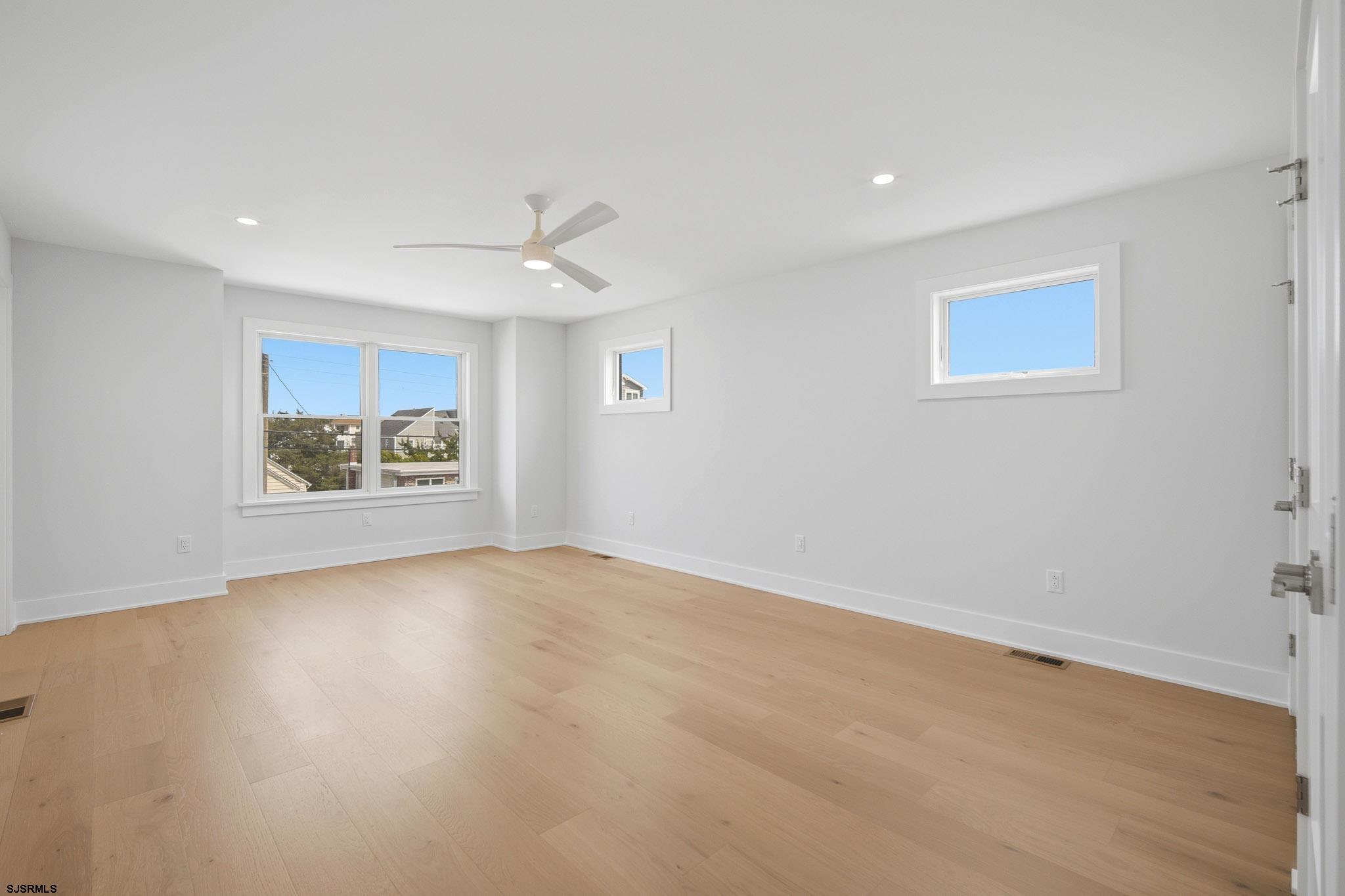 230 7th Street South Brigantine, NJ 08203 - Photo 46 of 87 an empty room with windows and ceiling fan
