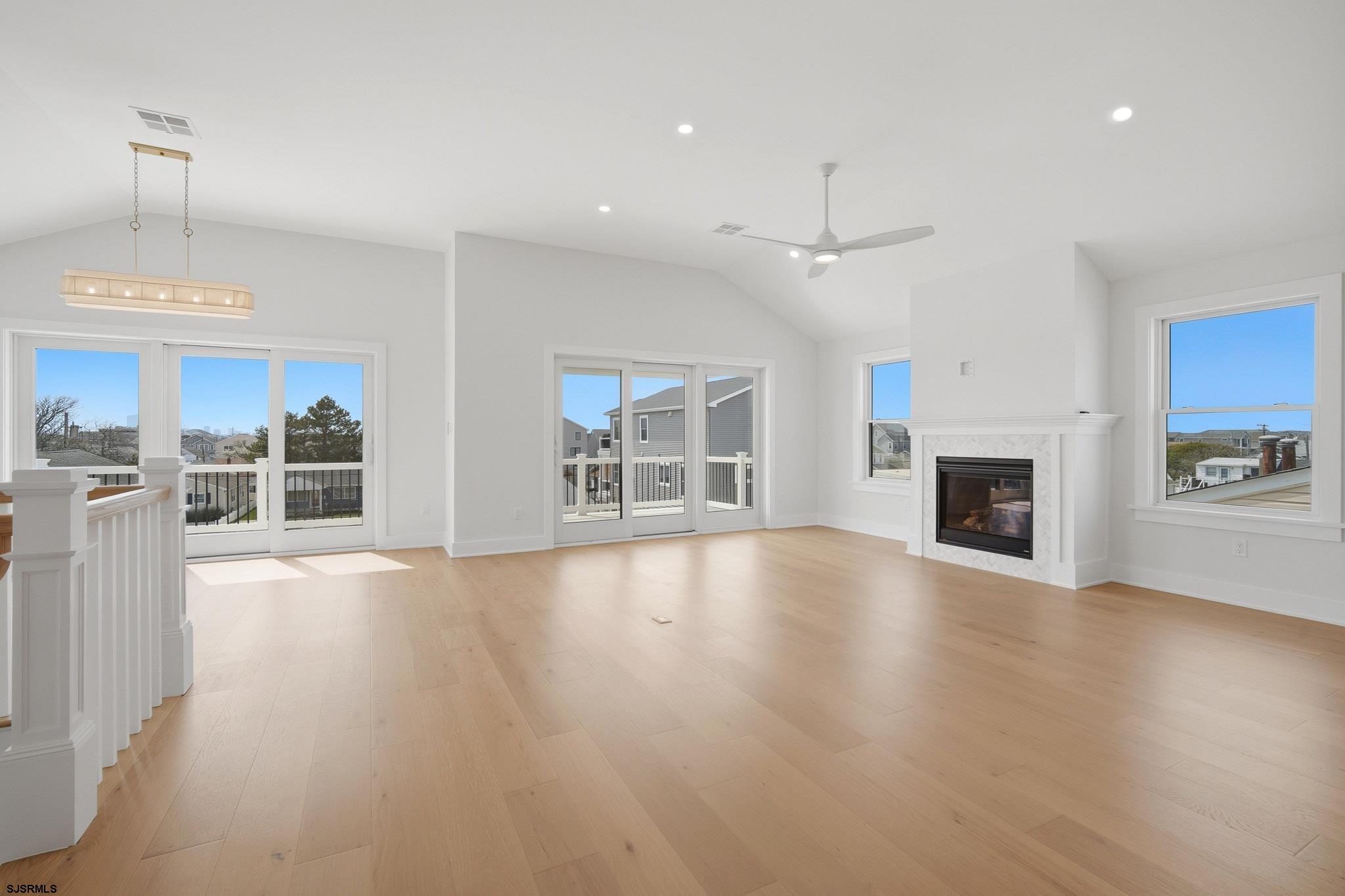 230 7th Street South Brigantine, NJ 08203 - Photo 51 of 87 an empty room with wooden floor fireplace and windows