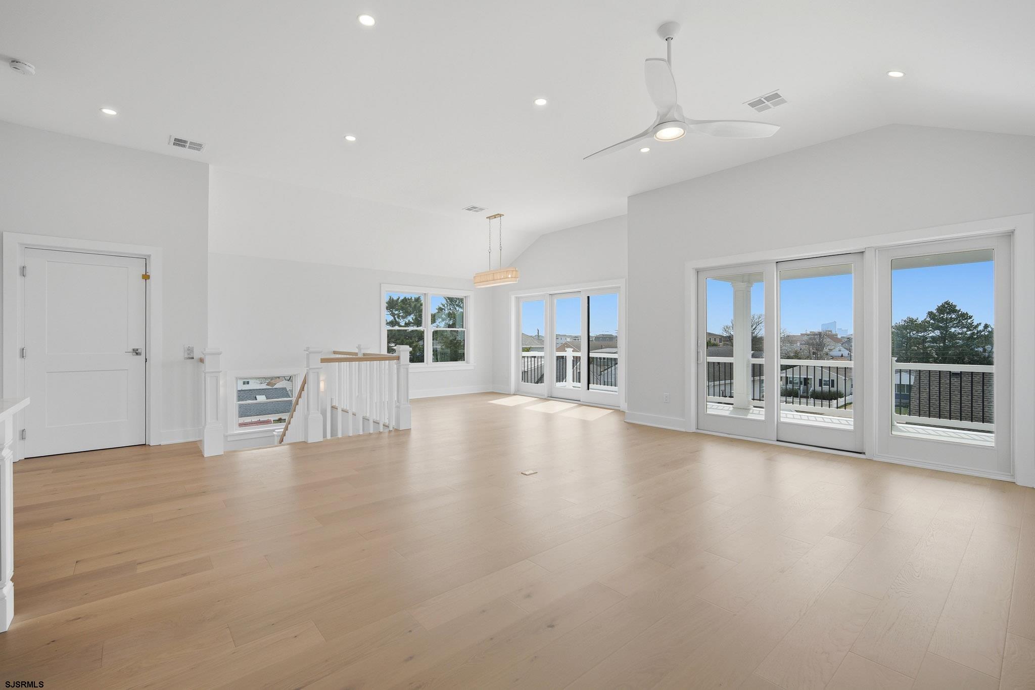 230 7th Street South Brigantine, NJ 08203 - Photo 52 of 87 a view of an empty room with wooden floor and a large window
