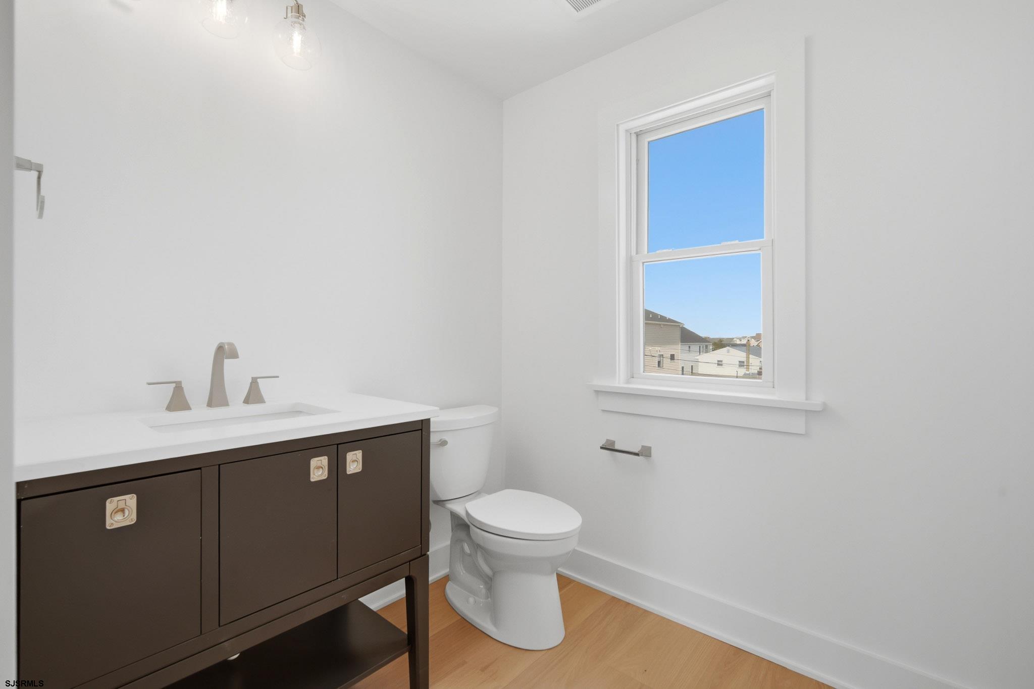 230 7th Street South Brigantine, NJ 08203 - Photo 60 of 87 a bathroom with a toilet a sink and mirror