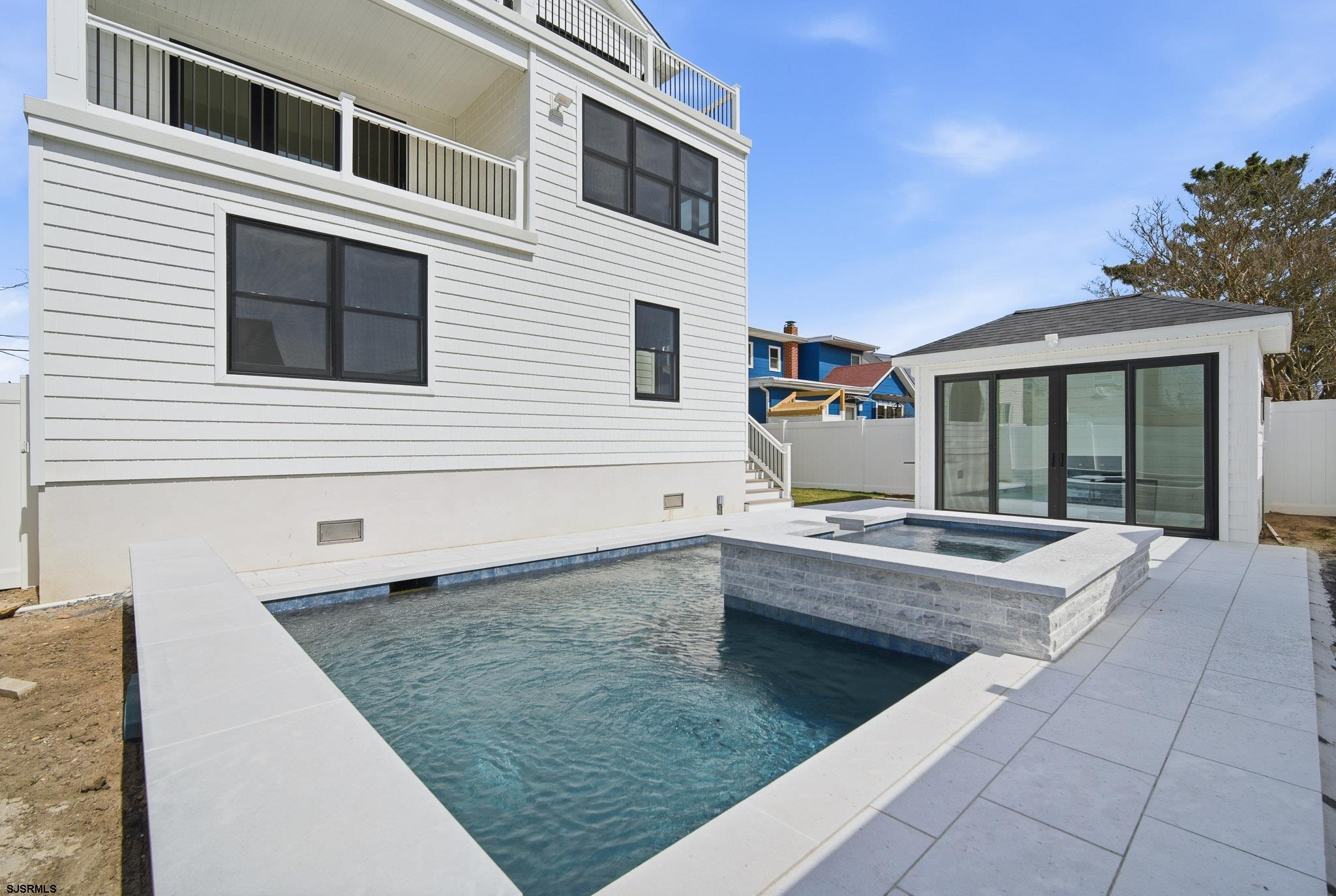 230 7th Street South Brigantine, NJ 08203 - Photo 7 of 87 a view of a house with sitting area and swimming pool