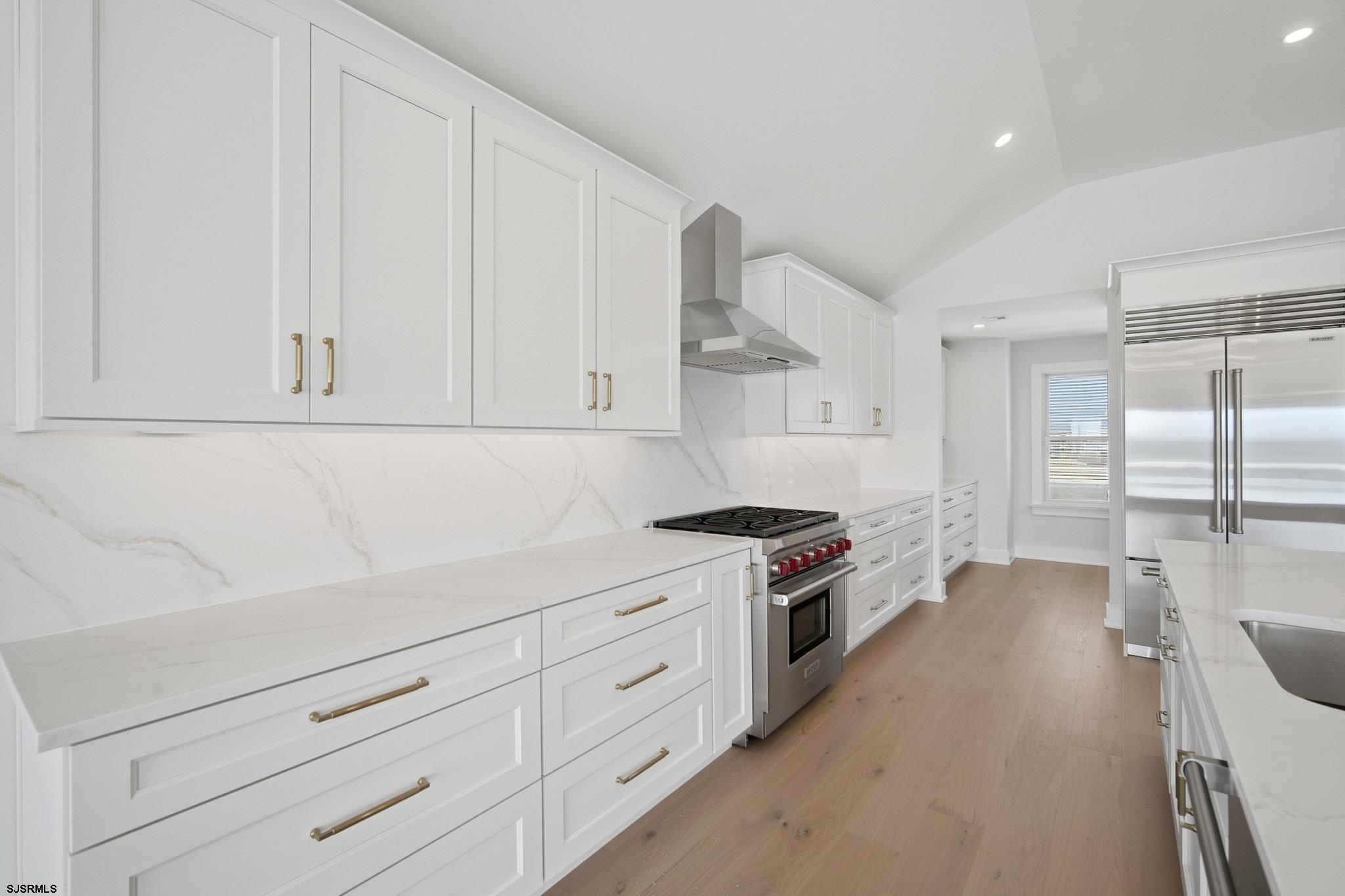 230 7th Street South Brigantine, NJ 08203 - Photo 73 of 87 a kitchen with granite countertop white cabinets and stainless steel appliances