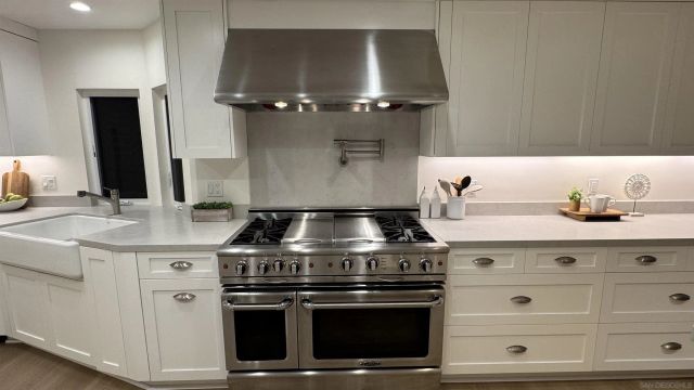 a stove top oven sitting inside of a kitchen