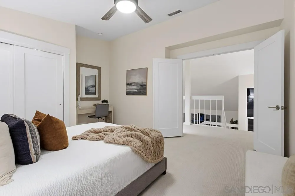 1711 Burgundy Road Encinitas, CA 92024 - Photo 18 of 45 a bedroom with a bed and a chandelier