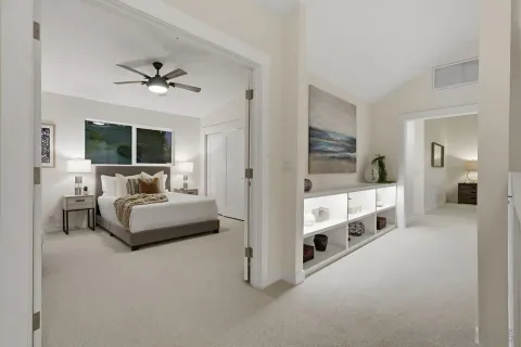 a large bedroom with a bed and chair