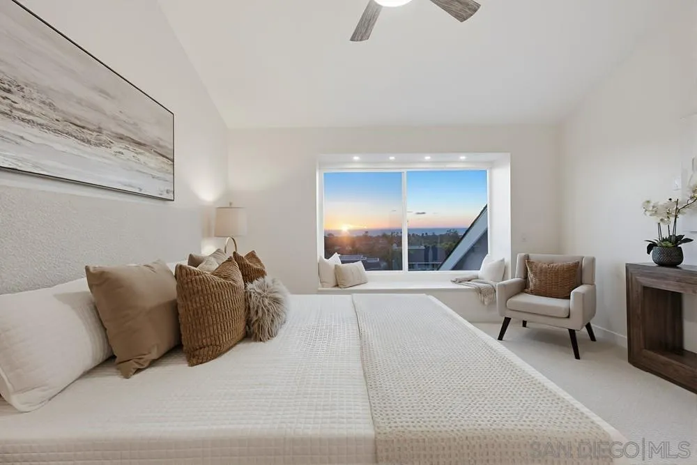 1711 Burgundy Road Encinitas, CA 92024 - Photo 20 of 45 a large bedroom with a bed and chair