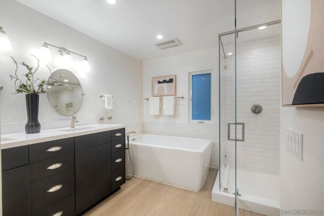 a bathroom with a bathtub and a shower