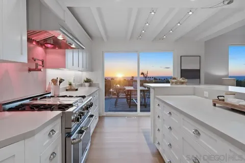 a kitchen with a stove a sink and a refrigerator