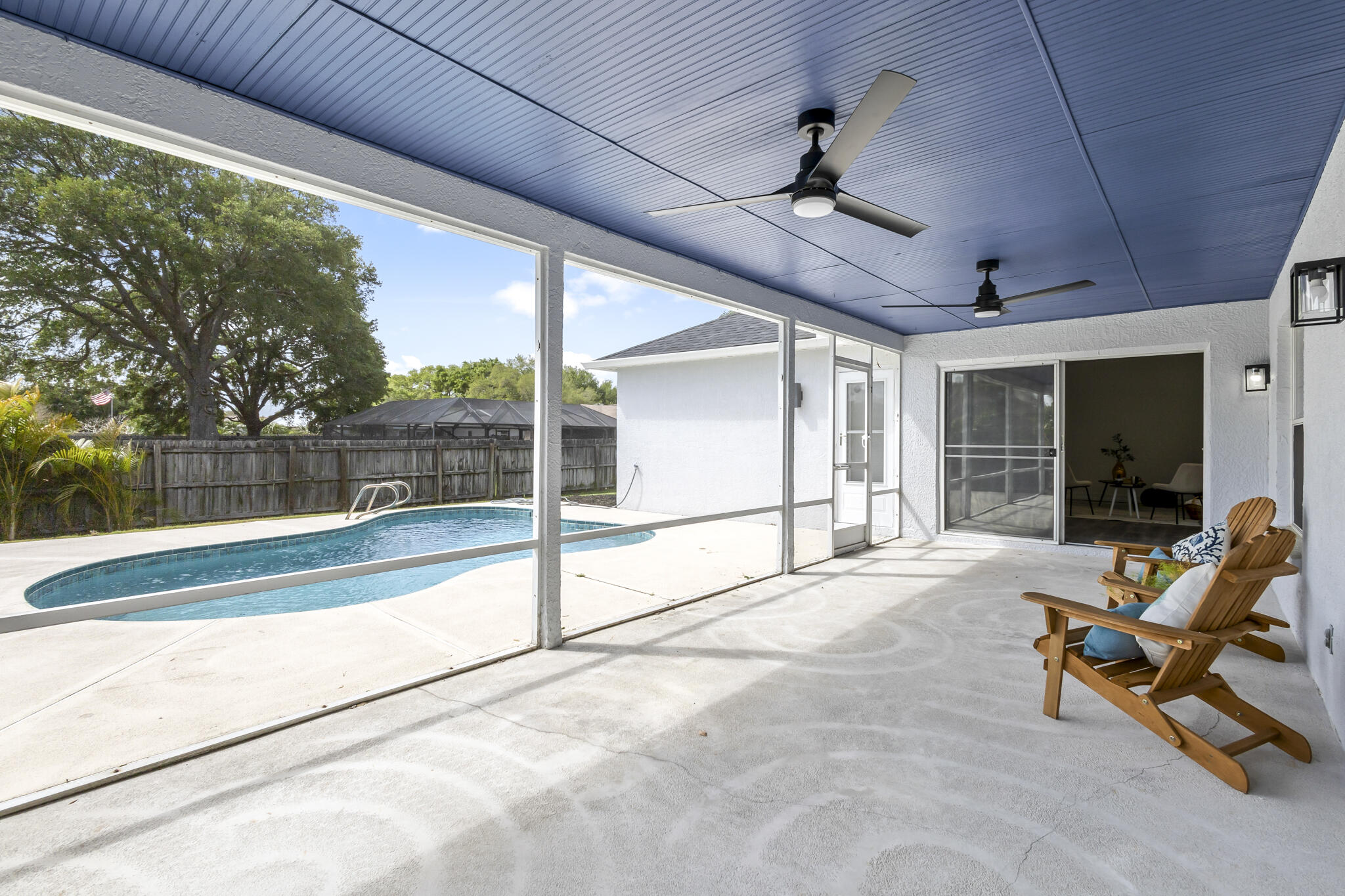 1695 Rustic Way Melbourne, FL 32935 - Photo 20 of 24 a view of a hall with floor to ceiling window and an outdoor space