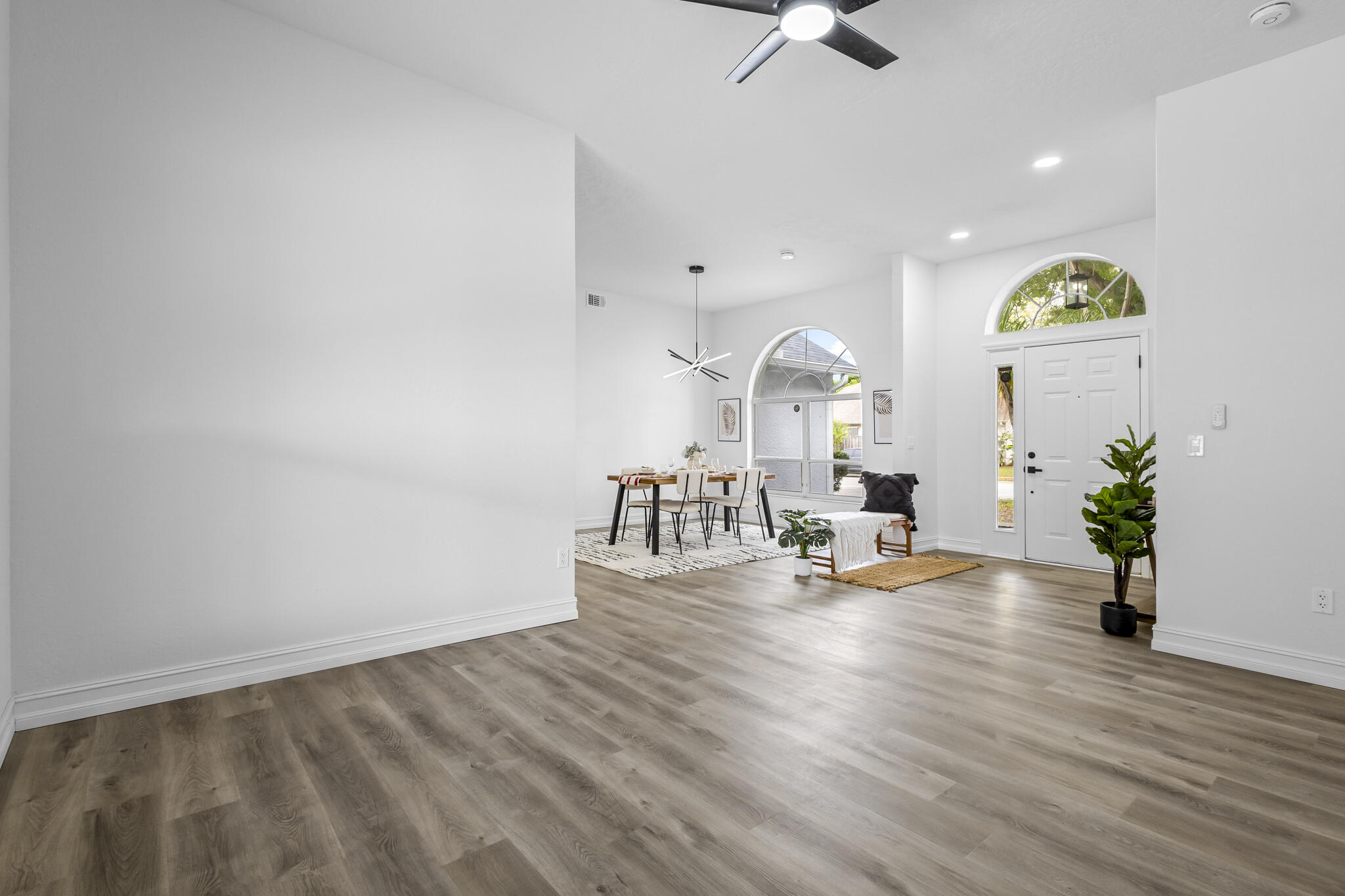 1695 Rustic Way Melbourne, FL 32935 - Photo 2 of 24 a living room with furniture and a chandelier