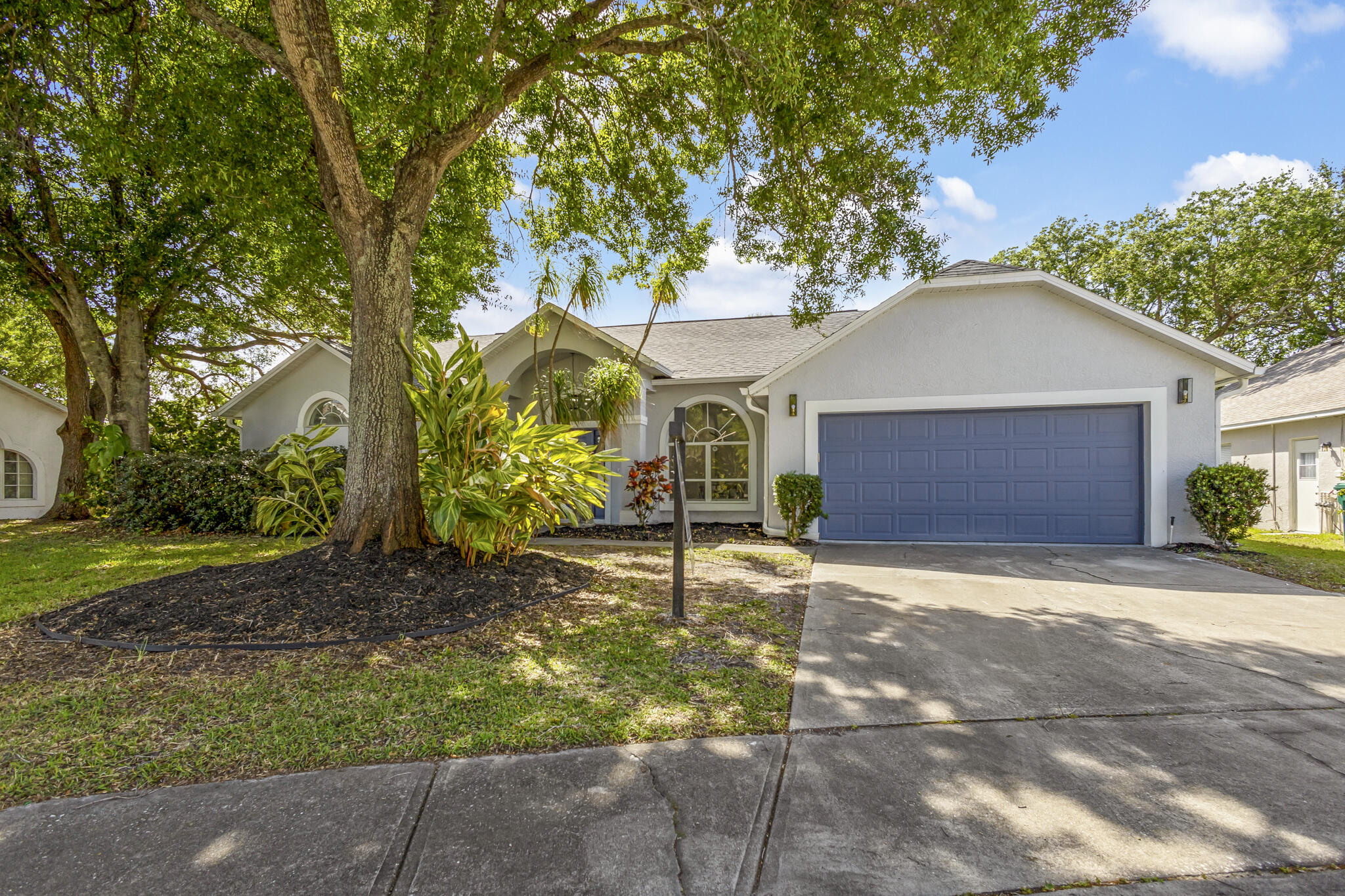 1695 Rustic Way Melbourne, FL 32935 - Photo 24 of 24 a front view of a house with a yard and garage