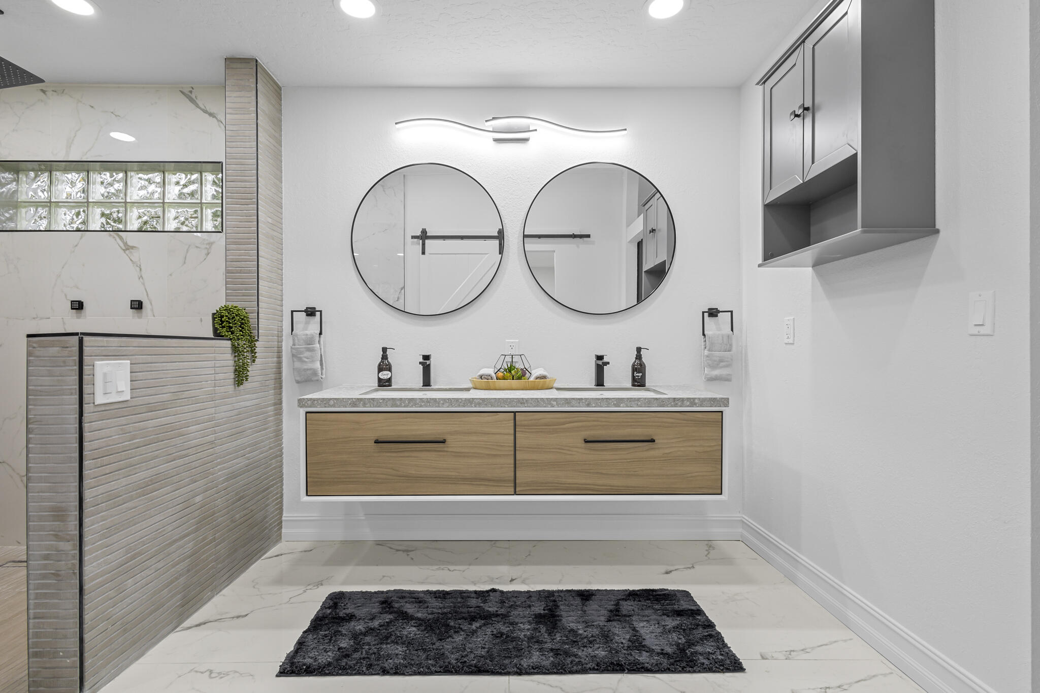 1695 Rustic Way Melbourne, FL 32935 - Photo 9 of 24 a bathroom with a double vanity sink mirror and a shower