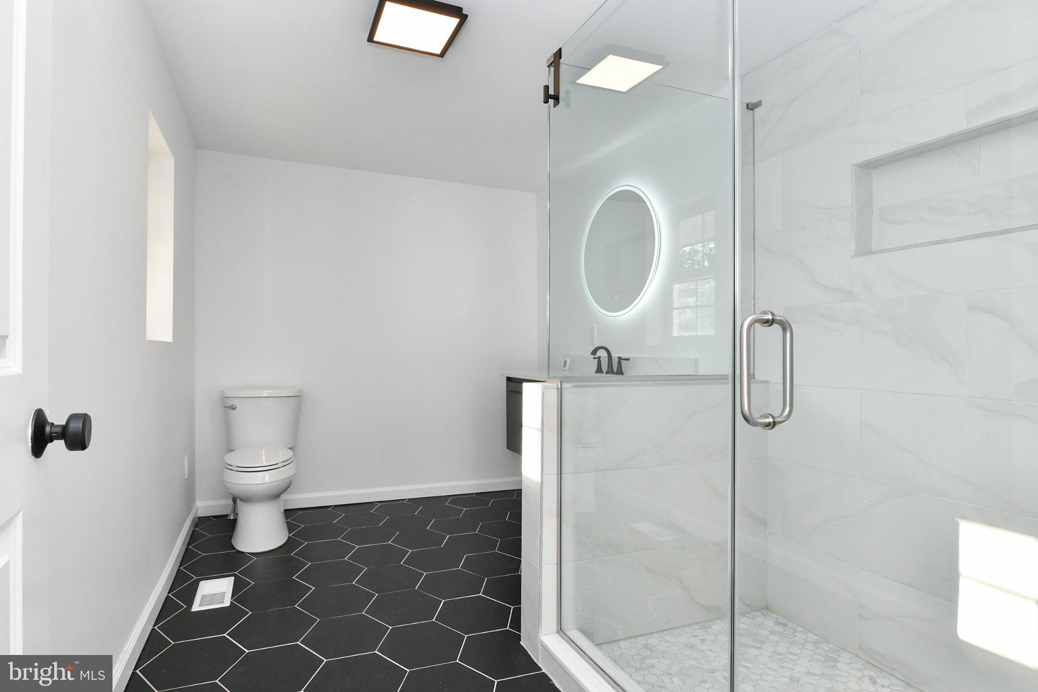 271 Friendship Road Cranbury, NJ 08512 - Photo 14 of 25 Sleek modern bathroom with elegant tiles.