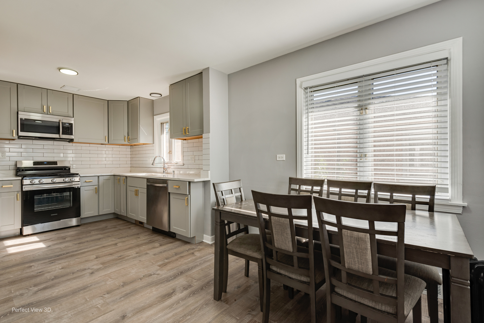 8152 North Ozark Avenue Niles, IL 60714 - Photo 8 of 28 a kitchen with a table chairs sink and microwave