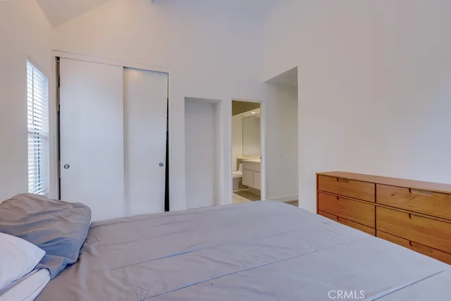 a bedroom with a bed and a dresser