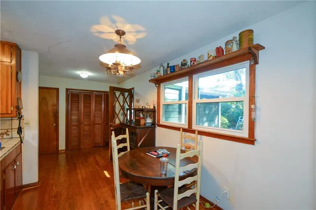 a view of a dining room with furniture wooden floor and chandelier