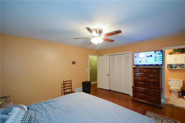 a bedroom with a bed and a chandelier