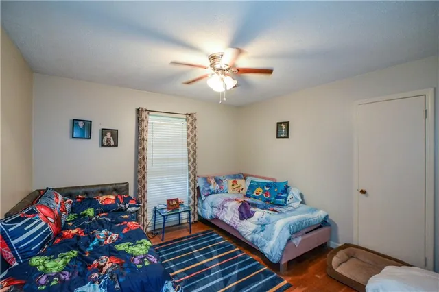 a bedroom with furniture and a wooden floor