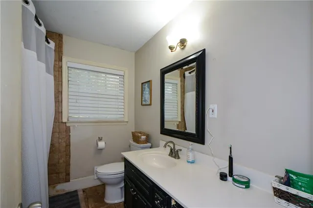 a bathroom with a toilet sink and mirror