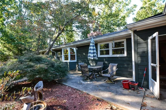 a view of backyard with outdoor seating and plants