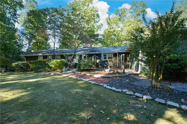 a view of a house with backyard porch and sitting area