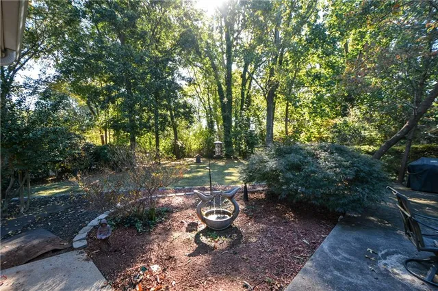 a view of a backyard with lawn chairs and a fire pit