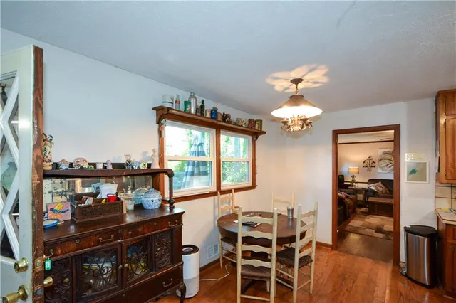 a living room with furniture a flat screen tv and a floor to ceiling window
