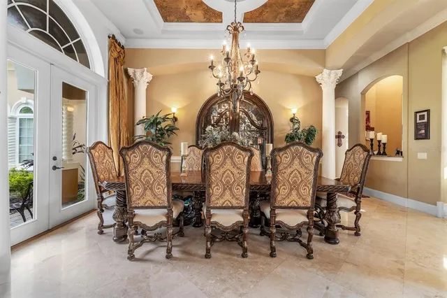 a view of a dining room with furniture and chandelier