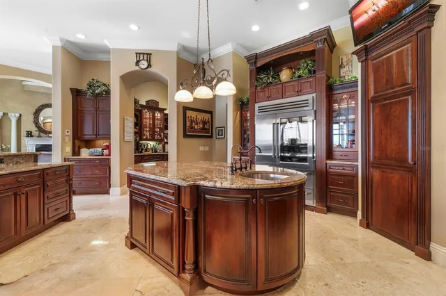 a kitchen with stainless steel appliances granite countertop a stove a sink and a refrigerator