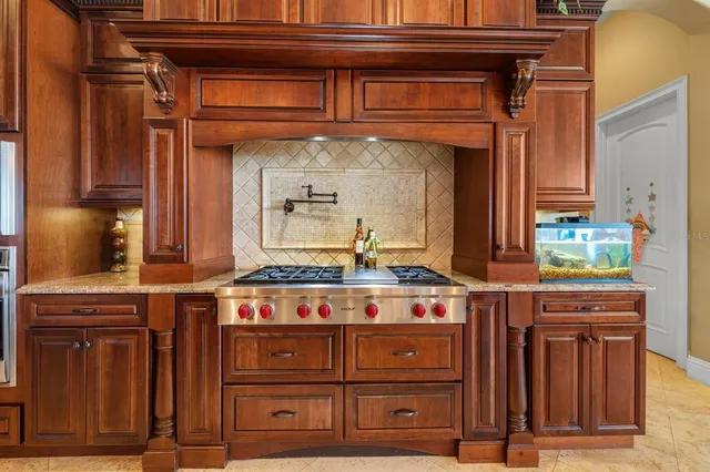 a kitchen with stainless steel appliances wooden cabinets and a stove top oven
