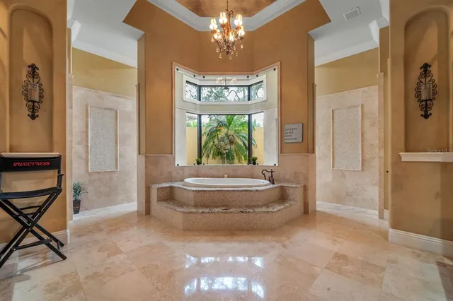 a spacious bathroom with a tub a mirror and a shower