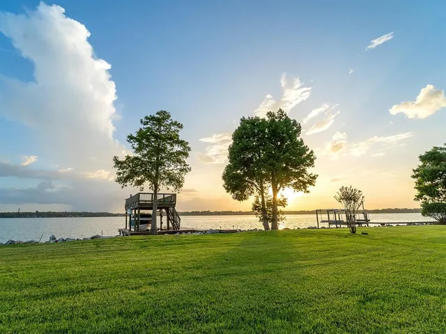 a view of swimming pool with outdoor seating and lake view