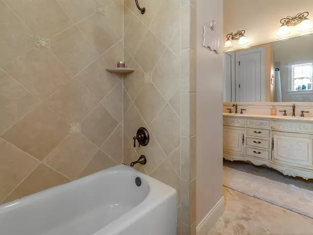 a bathroom with a double vanity sink and a mirror