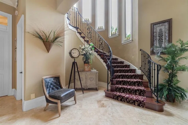a view of a hallway with wooden floor and stairs