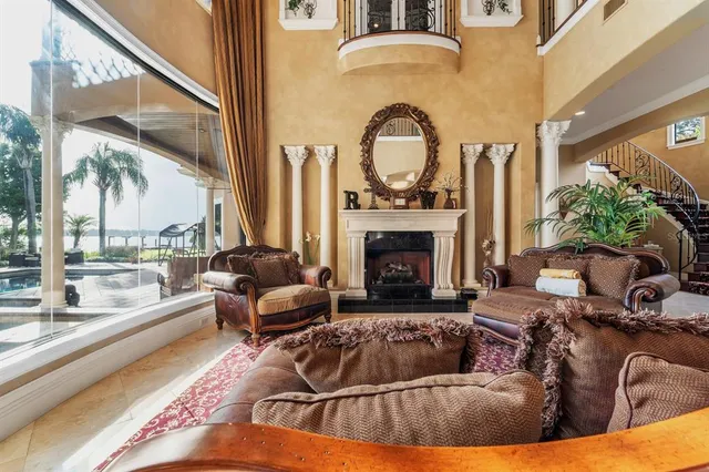 a living room with furniture fireplace and a large window