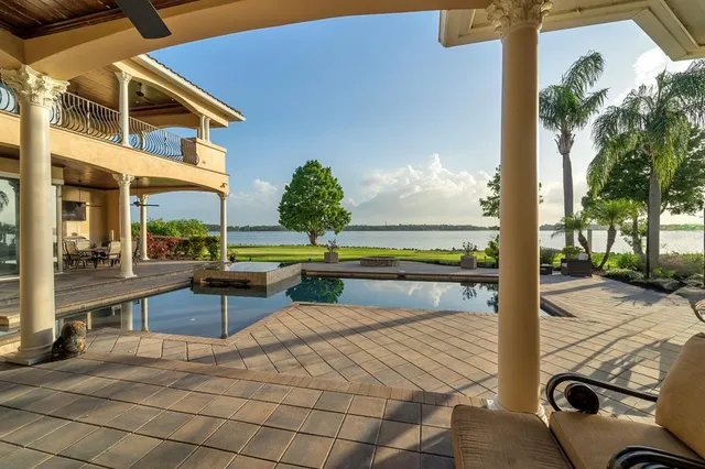 a front view of a house with a yard and a garden