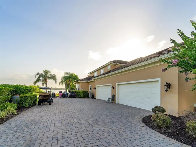 a living room with furniture a rug a fireplace and a large window