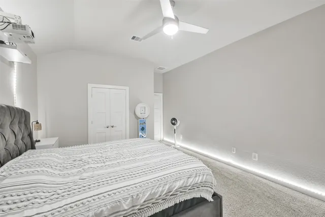 a bedroom with a bed and a lamp