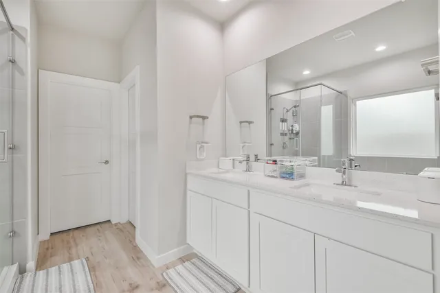 a bathroom with double vanity sinks and a mirror