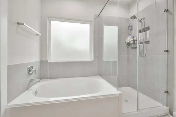 a white bath tub sitting next to a shower