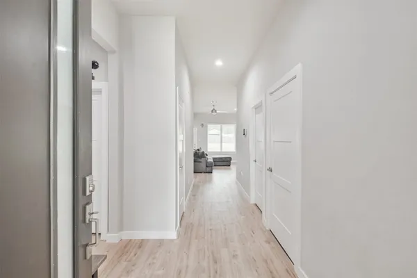 a view of a hallway with wooden floor