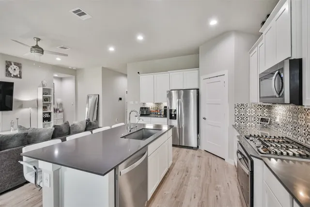 a kitchen with a sink stove and refrigerator