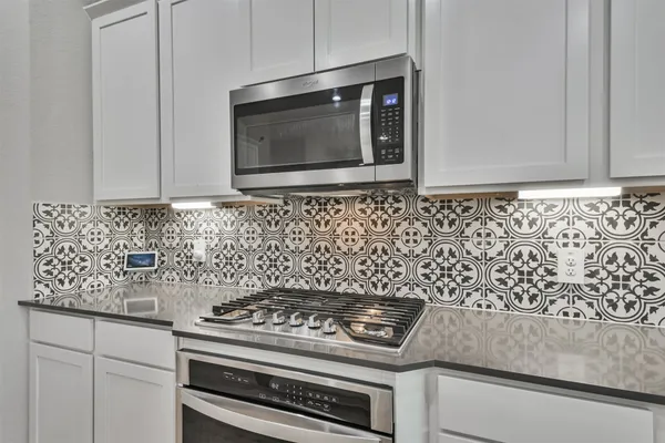 a kitchen with a stove and microwave