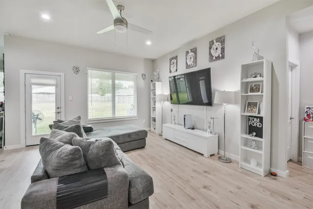 a living room with furniture and a flat screen tv