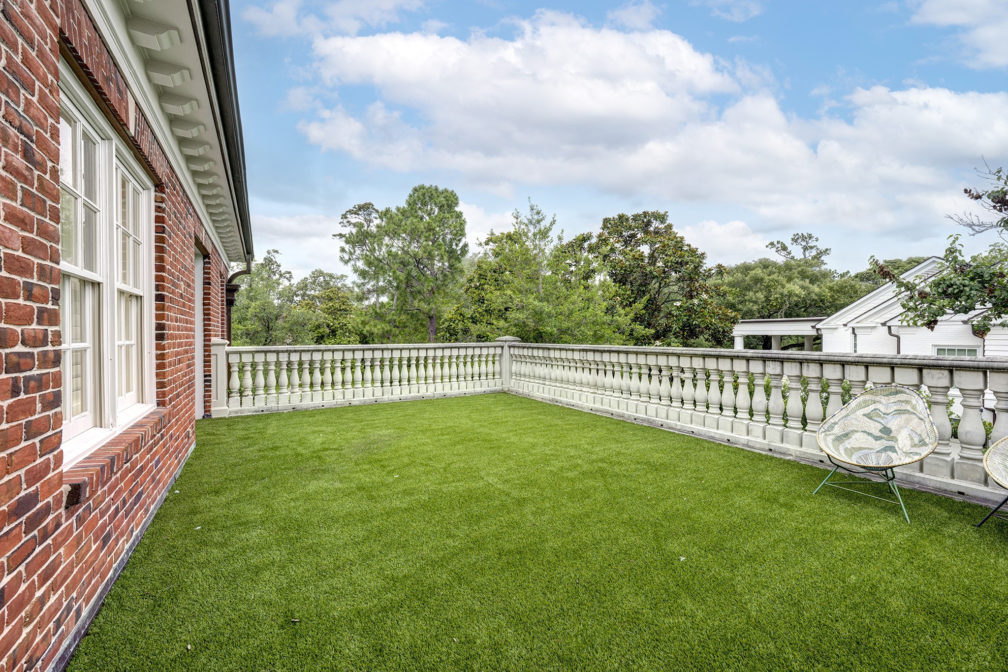 3653 Inverness Drive Houston, TX 77019 - Photo 39 of 39 The second-floor landing features a terrace with turf and a cast stone railing, offering the perfect spot for al fresco dining.
