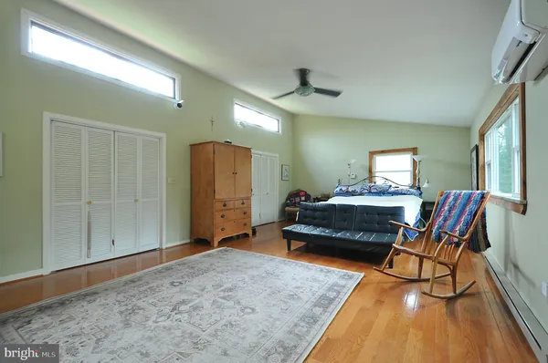 a bedroom with furniture and a wooden floor