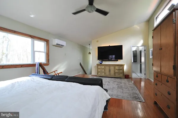 a bedroom with a bed and a flat screen tv